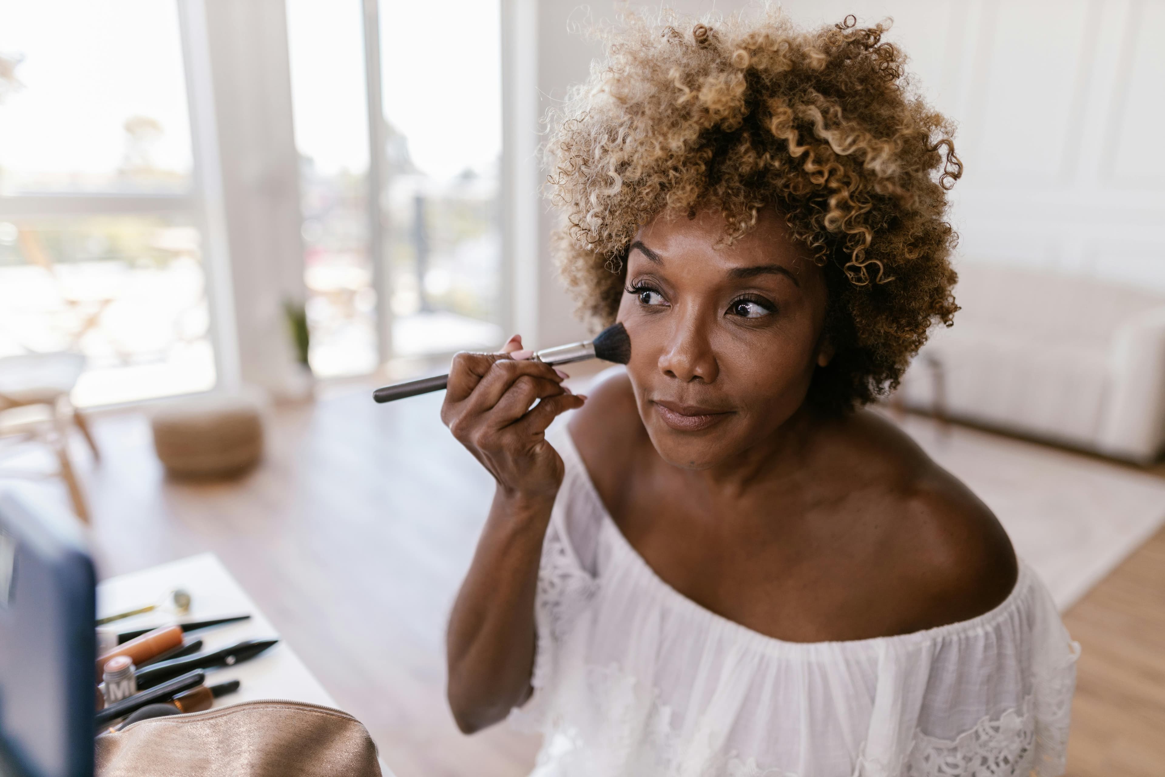 Woman applying makeup — quiet moment of self-care